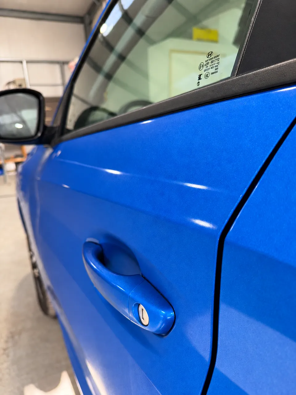 Door and rear quarter refinished, colour matched to the metallic blue