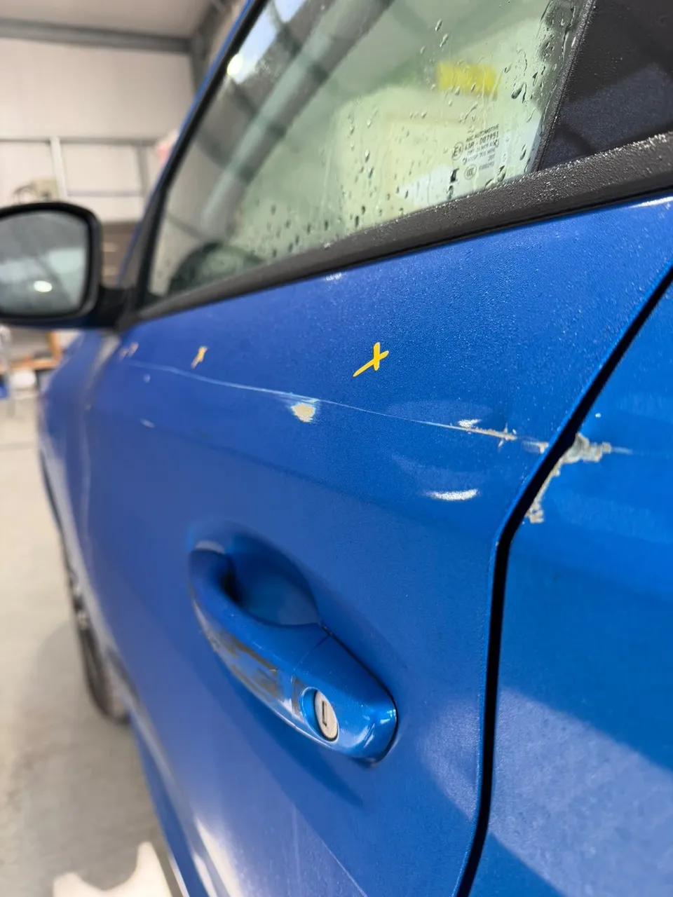 Scratched door and rear quarter, marked up before repair